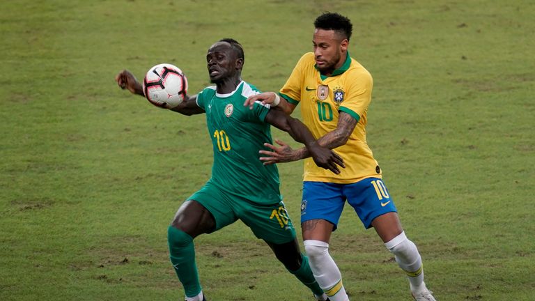 Liverpool's Sadio Mane tussles with Neymar