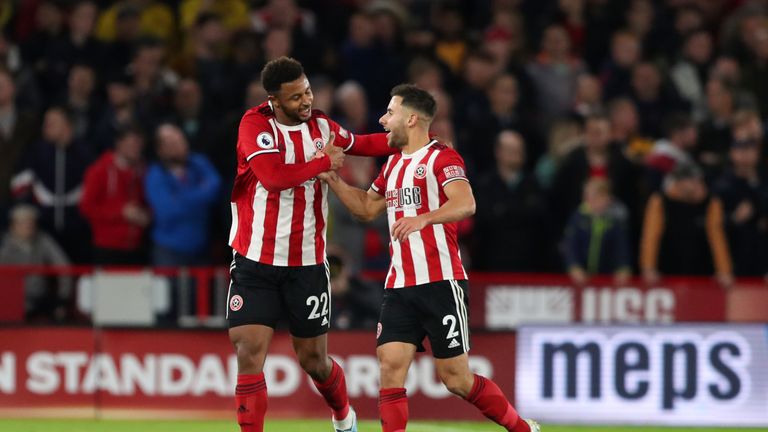 Goalscorer Lys Mousset celebrates with George Baldock during their victory over the Gunners