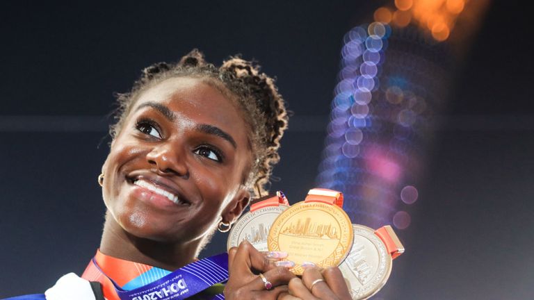 Dina Asher-Smith poses with her medals from this year's IAAF Athletics World Championships