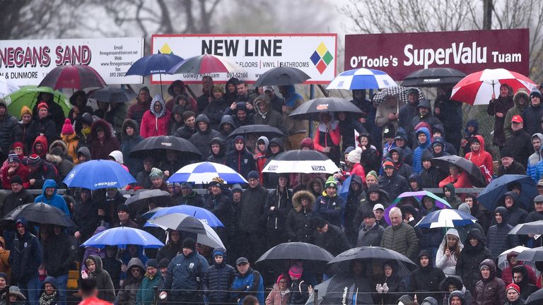 There through it all! Spectators brave the elements to watch the Galway county final in Tuam