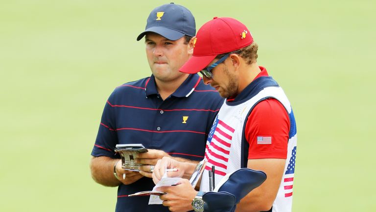 Patrick Reed talks with his caddie Kessler Karain