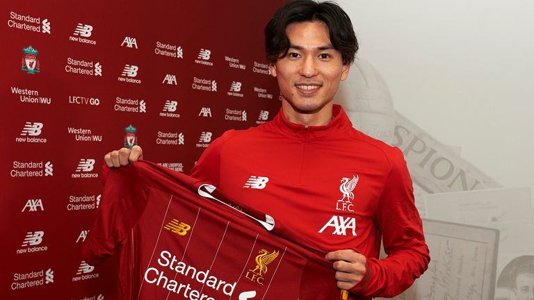 Minamino pictured with a Liverpool shirt after his signing