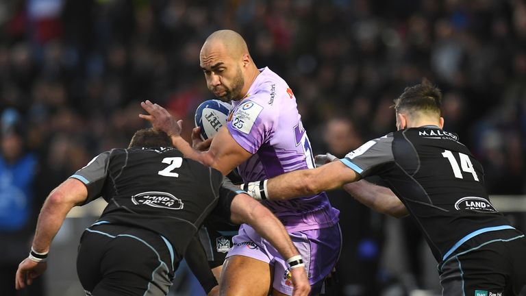 Exeter's Olly Woodburn is tackled by Fraser Brown