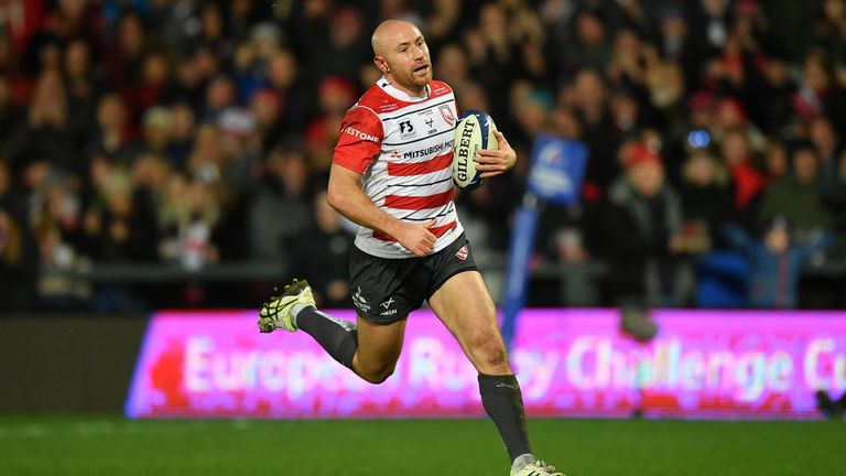 Willi Heinz makes a break to score Gloucester's first try