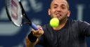 Evans survives match points to advance