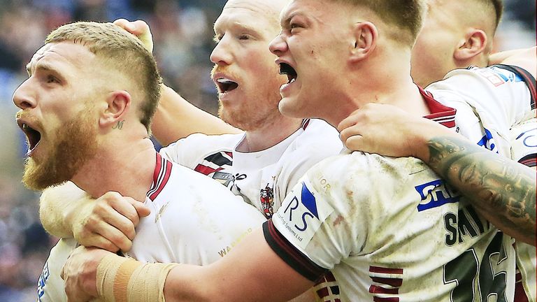 Jackson Hastings (left) leads the celebrations after scoring Wigan's third try