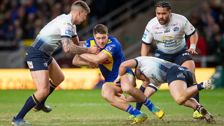  Tom Lineham is tackled by Leeds's Alex Mellor & Brad Dwyer