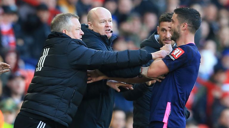 Chris Wilder and Andrew Surman exchange shoves on the touchline