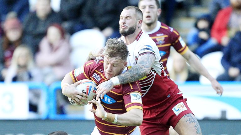 Aaron Murphy tackled by Wigan's Thomas Leuluai and Zak Hardaker