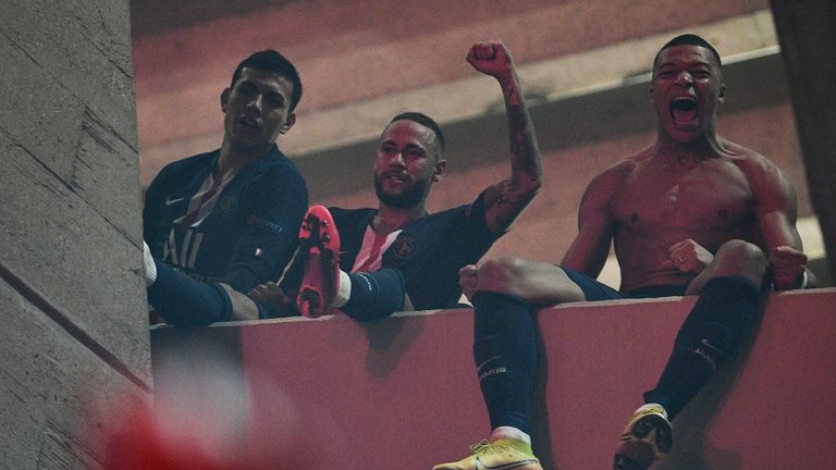 Neymar and Kylian Mbappe celebrate on a balcony with fans outside the ground