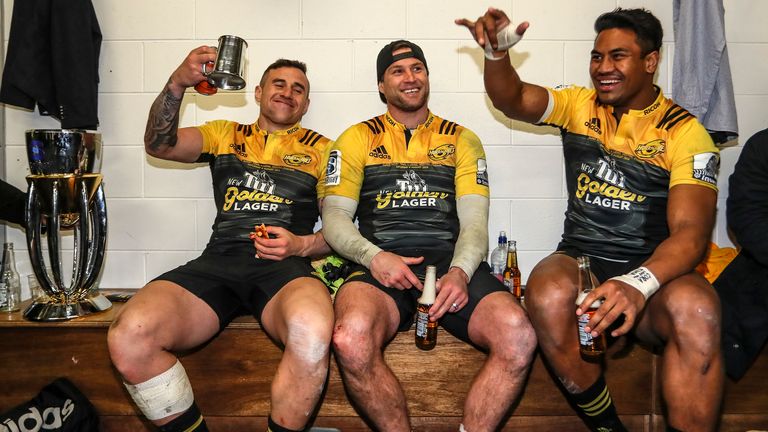 TJ Perenara, Cory Jane and Savea celebrate after the Hurricanes beat the Lions in the 2016 Super Rugby final