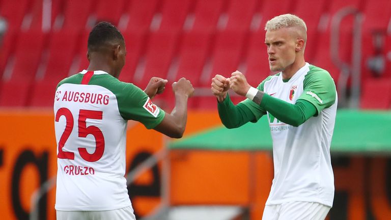 Phillip Max celebrates his equaliser for Augsburg against Cologne