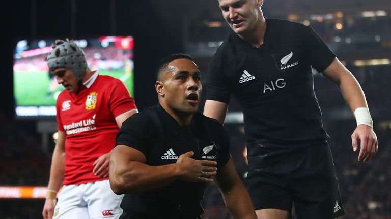 Ngani Laumape celebrates scoring with a disappointed Jonathan Davies in the background
