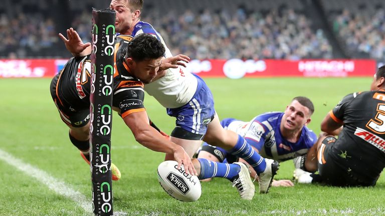David Nofoaluma produces a spectacular finish despite the efforts of Kieran Foran
