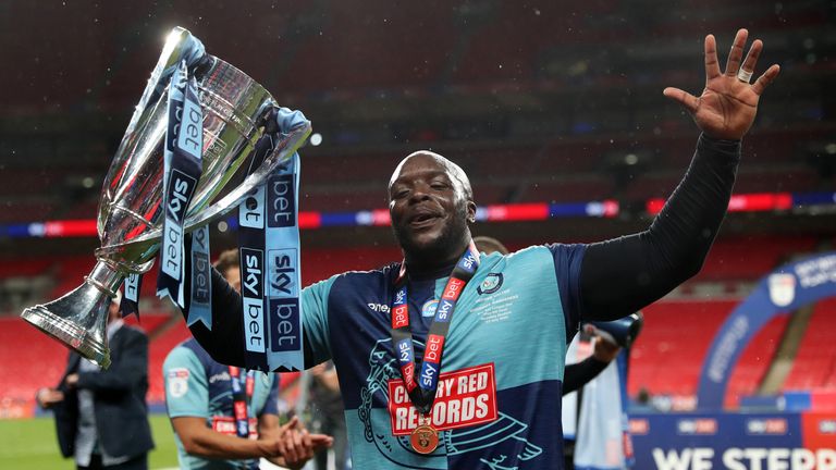 Adebayo Akinfenwa celebrates after Wycombe booked their place in the Championship for next season