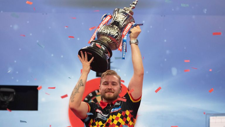Dimitri Van den Bergh made his major breakthough in Milton Keynes last year when he lifted the Phil Taylor Trophy (Image: Lawrence Lustig/PDC)
