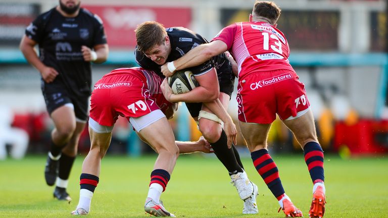 Dragons' Aaron Wainwright is tackled by Steffan Hughes 