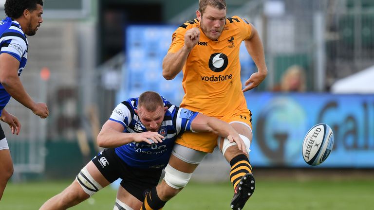 Joe Launchbury kicks ahead despite the efforts of Bath's Sam Underhill