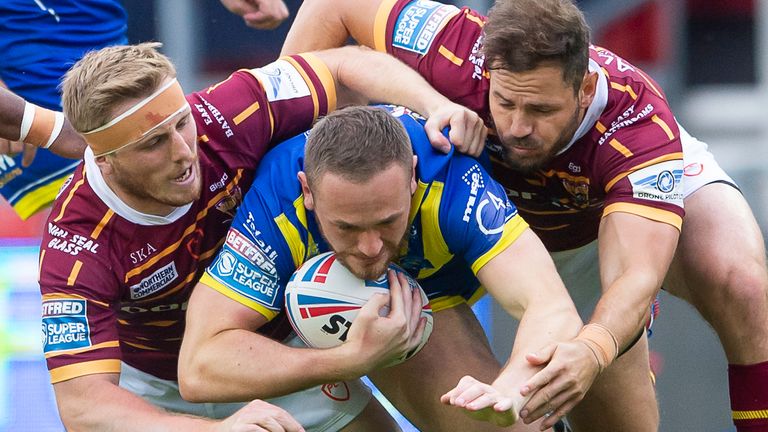 Warrington tryscorer Ben Currie is tackled by Adam O'Brien and Aiden Sezer