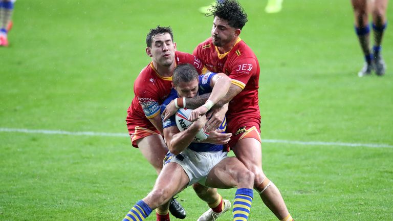 Leeds Rhinos' Jack Walker is wrapped up by Catalans tacklers