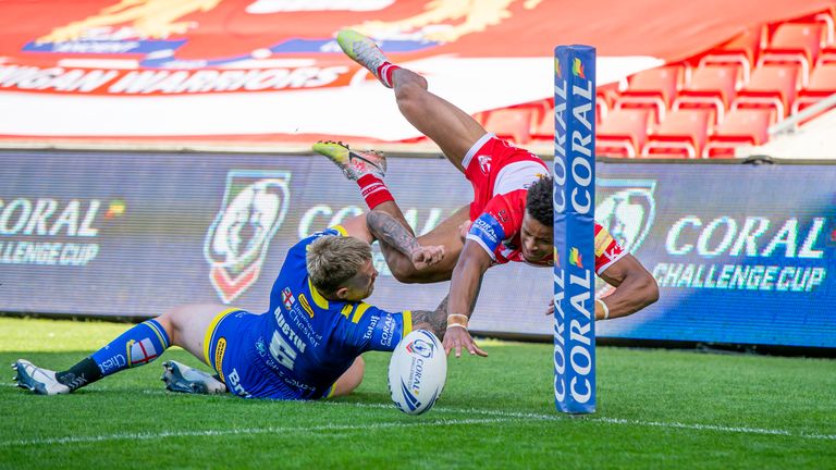 Blake Austin pushes St Helens's Regan Grace into touch before he can touch down for a try