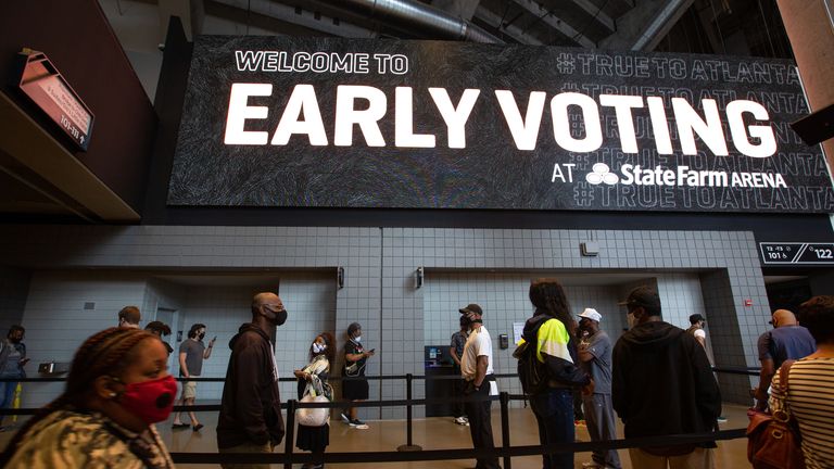 Voters line up inside State Farm Arena, Georgia's largest early voting location, on the first day of early voting 