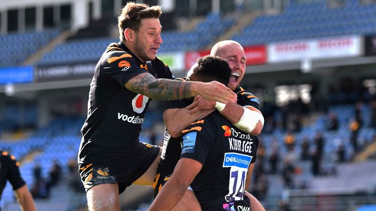 Zach Kibirige is congratulated by Matteo Minozzi and Dan Robson of Wasps