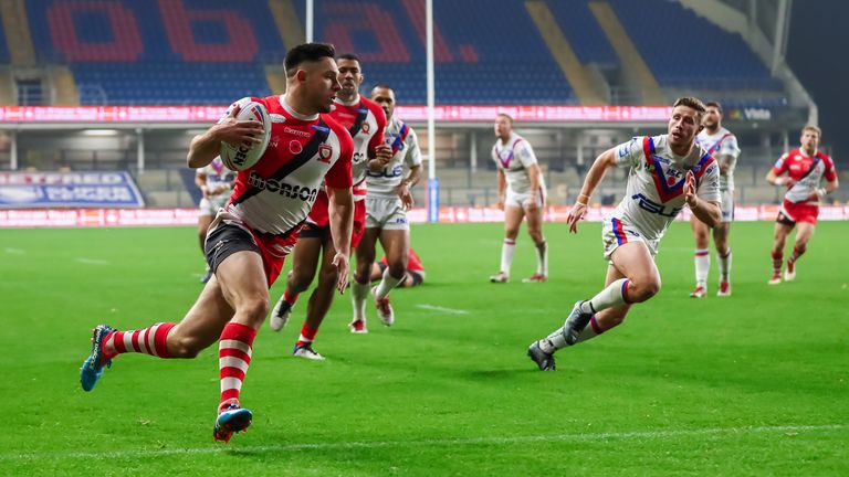  Salford's Niall Evalds runs in for a try.