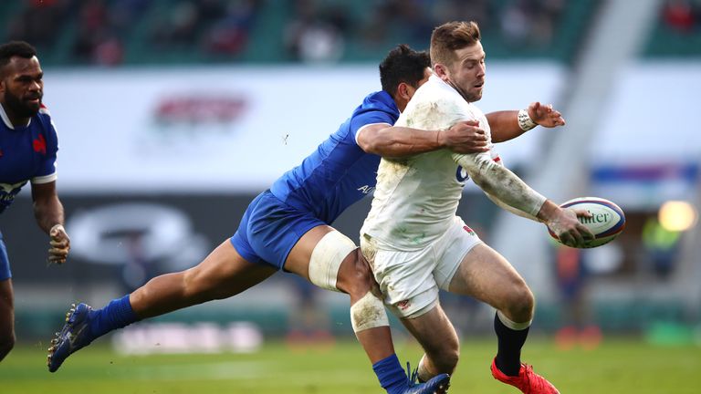 Elliot Daly of England is tackled by Yoram Moefana 