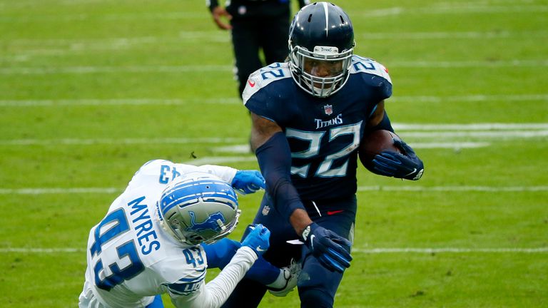Titans running back Derrick Henry throws a Detroit defensive back out of bounds with a stiff-arm.