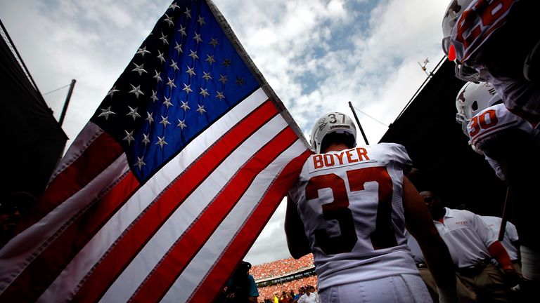 Boyer carries an American flag in 2012 as the Texas Longhorns take to the field at Cotton Bowl in Dallas, Texas