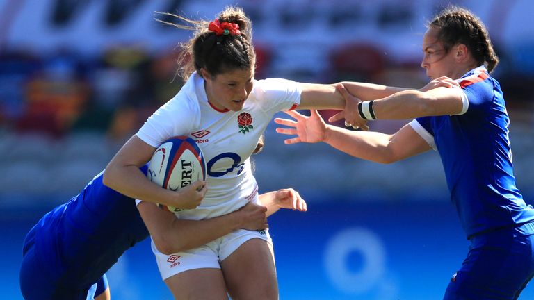 England's Jess Breach (centre) is tackled as she attempts to charge through