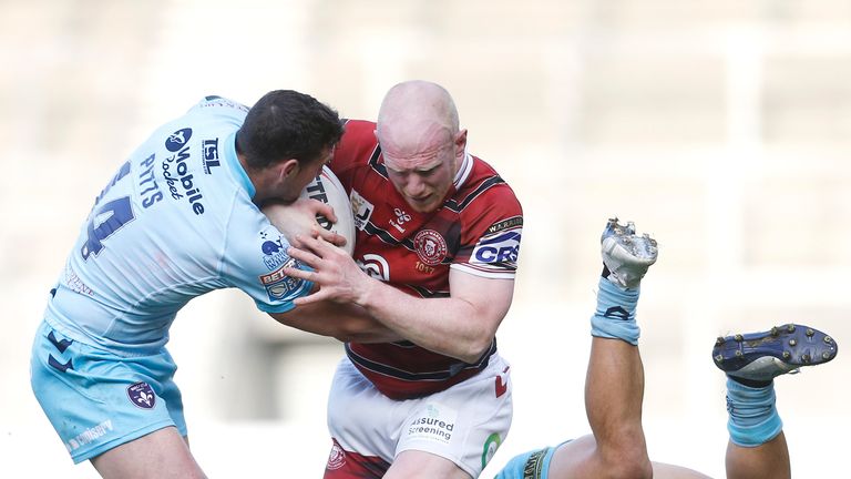  Wigan Warriors' Liam Farrell in action with Wakefield Trinity's Jay Pitts and Mason Lino