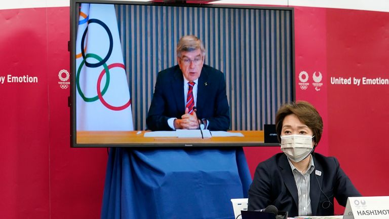 IOC president Thomas Bach (on a screen) delivers an opening speech while Tokyo 2020 Organising Committee president Seiko Hashimoto watches on            