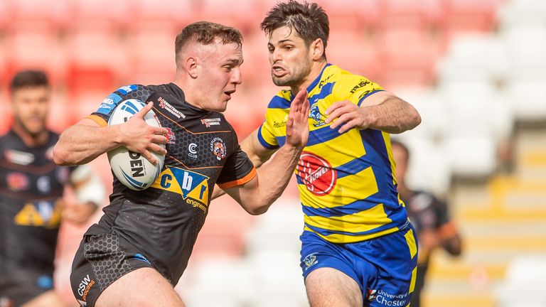 Castleford's Jake Trueman attempts to evade Warrington's Jake Mamo