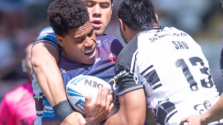 St Helens' Kevin Naiqama is tackled by Hull FC's Andre Savelio and Ligi Sao