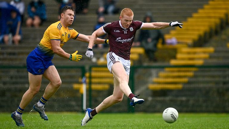 Peter Cooke of Galway has a shot at goal despite the attention of Niall Daly of Roscommon