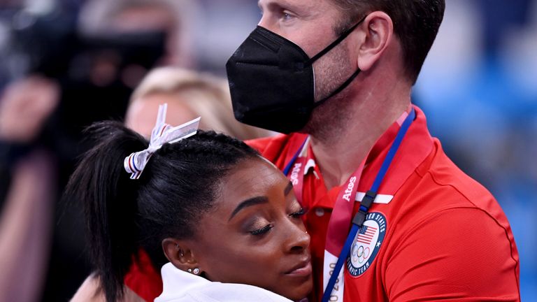 Biles was comforted by a USA coach during the women's team event 