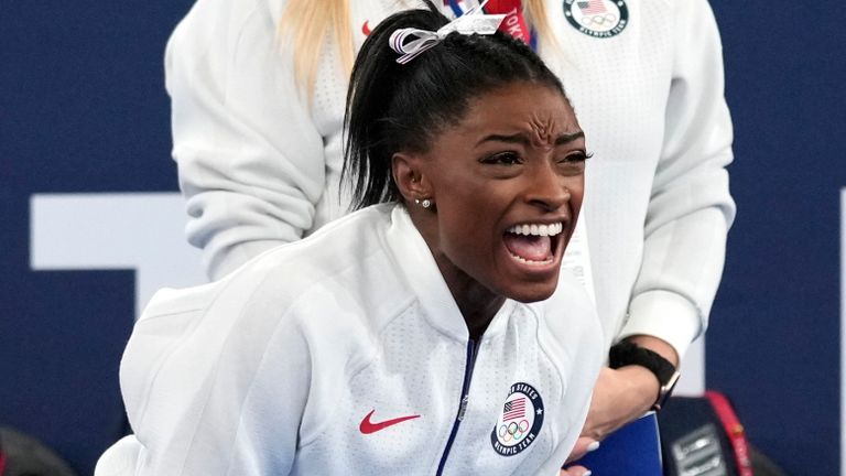 Biles cheered on her USA team-mates after withdrawing