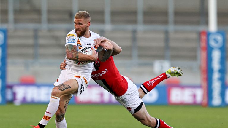 Sam Tomkins is tackled by Salford Red Devils' Dan Sarginson