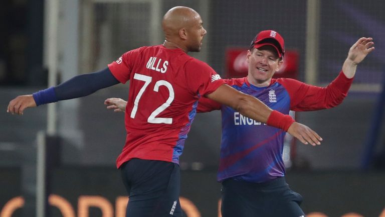 Tymal Mills celebrates with Morgan after taking the wicket of Chris Gayle