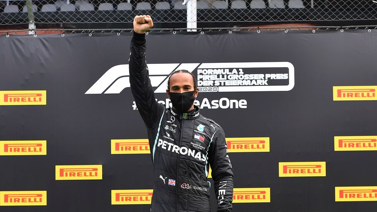 Lewis Hamilton celebrates on the podium with his fist in the air after winning the Styrian Formula One Grand Prix in July 2020