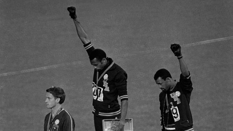 US athletes Tommie Smith (centre) and John Carlos protesting on the podium in Mexico City on October 16 in 1968