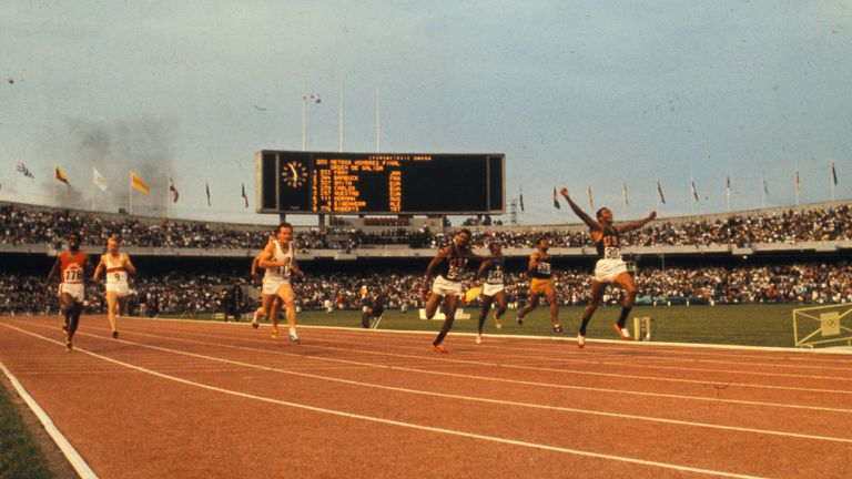 Smith with his arms raised winning gold in the 200m in 1968 