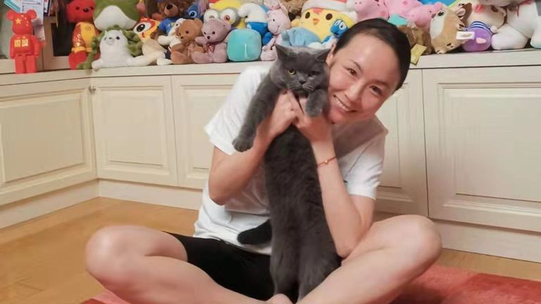 Peng, 35, was seen smiling with a grey cat while surrounded by soft toys in a 'new' photo shared on Friday