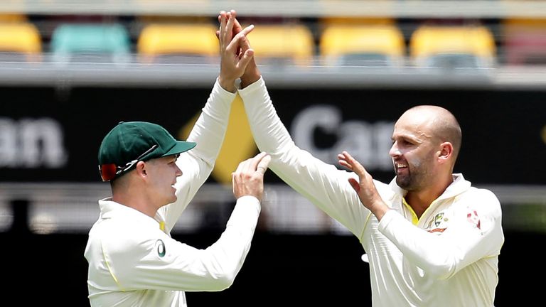 Nathan Lyon (R) celebrates an England wicket with Peter Handscomb at the Gabba
