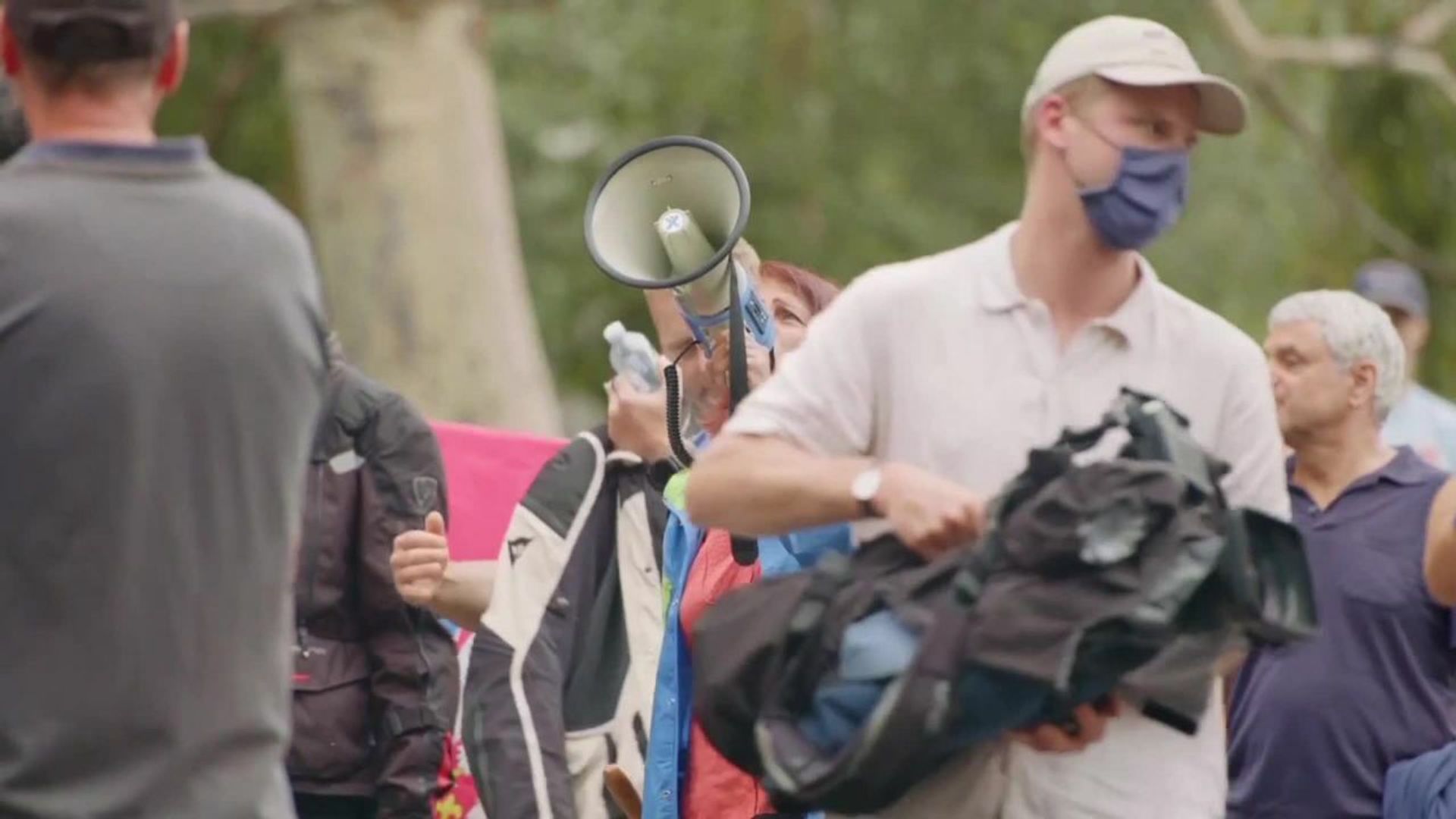 Djokovic protestors gather outside hotel