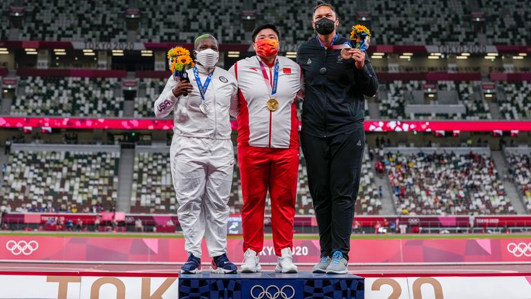 China's Gong Lijiao poses with her gold medal next to Saunders with New Zealand's Valerie Adams getting the bronze medal