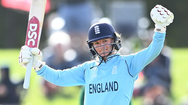 Danni Wyatt raises her bat after scoring a century during the 2022 ICC Women's Cricket World Cup Semi Final against South Africa 