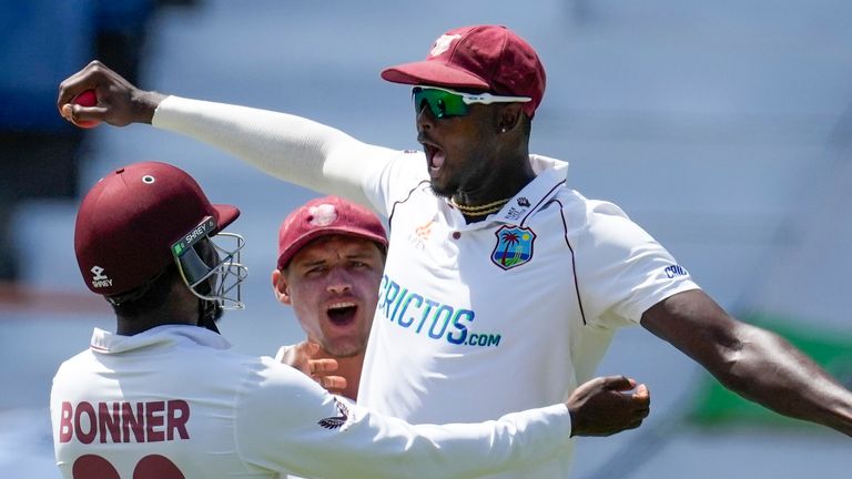 Jason Holder celebrates after pulling off a stunning catch at leg slip to dismiss Chris Woakes on the fourth morning